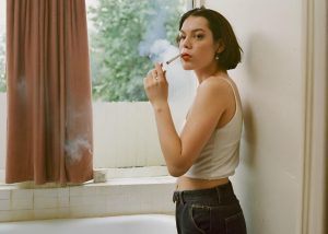 Woman-smoking-in-the-bathroom-next-to-the-window